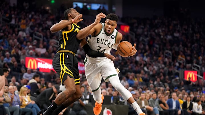 Mar 6, 2024; San Francisco, California, USA; Milwaukee Bucks forward Giannis Antetokounmpo (34) drives past Golden State Warriors forward Jonathan Kuminga (00) in the second quarter at the Chase Center. Mandatory Credit: Cary Edmondson-Imagn Images