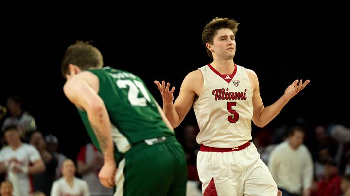 Miami RedHawks guard Peter Suder (5) reacts after hitting a jump shot over Ohio Bobcats guard Jesse Burris (21) in the second half of the NCAA basketball game at Millett Hall in Oxford, Ohio, on Friday, Feb. 13, 2026. Miami RedHawks guard Peter Suder (5) reacts after hitting a jump shot over Ohio Bobcats guard Jesse Burris (21) in the second half of the NCAA basketball game at Millett Hall in Oxford, Ohio, on Friday, Feb. 13, 2026.