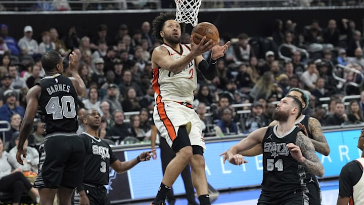 Feb 21, 2025; Austin, Texas, USA; Detroit Pistons guard Cade Cunningham (2) drives to the basket between San Antonio Spurs forwards Harrison Barnes (40) and Sandro Mamukelashvili (54) during the second half at Moody Center. Mandatory Credit: Scott Wachter-Imagn Images