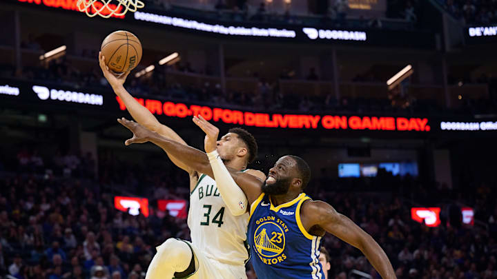 Jan 7, 2026; San Francisco, California, USA; Milwaukee Bucks forward Giannis Antetokounmpo (34) shoots the ball against Golden State Warriors forward Draymond Green (23) during the second quarter at Chase Center. Mandatory Credit: Robert Edwards-Imagn Images