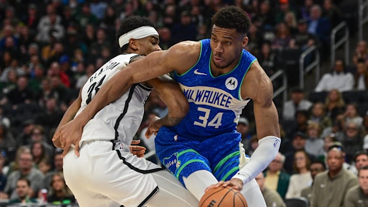 Mar 21, 2024; Milwaukee, Wisconsin, USA;  Milwaukee Bucks forward Giannis Antetokounmpo (34) drives around Brooklyn Nets center Nicolas Claxton (33) in the second quarter at Fiserv Forum. Mandatory Credit: Benny Sieu-Imagn Images