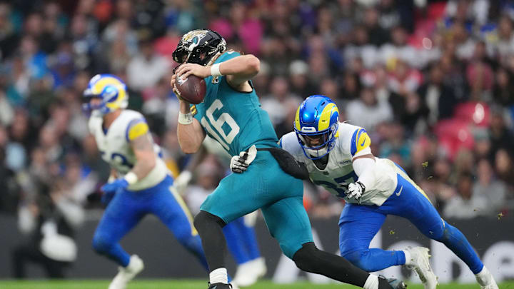 Oct 19, 2025; London, United Kingdom; Los Angeles Rams safety Quentin Lake (37) sacks Jacksonville Jaguars quarterback Trevor Lawrence (16) during the second half of an NFL International Series game at Wembley Stadium. Mandatory Credit: Kirby Lee-Imagn Images