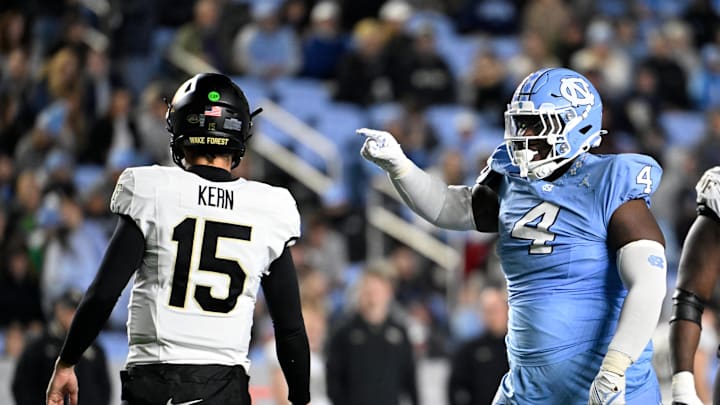 Nov 16, 2024; Chapel Hill, North Carolina, USA; North Carolina Tar Heels defensive lineman Travis Shaw (4) reacts after making a tackle as Wake Forest Demon Deacons quarterback Michael Kern (15) looks to the sideline in the third quarter at Kenan Memorial Stadium. 