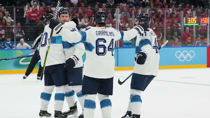Feb 20, 2026; Milan, Italy; Mikko Rantanen (96) of Finland celebrates with teammates after scoring a goal during the first period against Canada in a men's ice hockey semifinal during the Milano Cortina 2026 Olympic Winter Games at Milano Santagiulia Ice Hockey Arena. Mandatory Credit: James Lang-Imagn Images