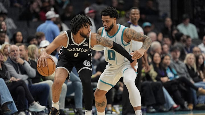 Jan 29, 2025; Charlotte, North Carolina, USA;  Brooklyn Nets forward Trendon Watford (9) handles the ball against Charlotte Hornets forward Miles Bridges (0) during the second half at Spectrum Center. Mandatory Credit: Jim Dedmon-Imagn Images