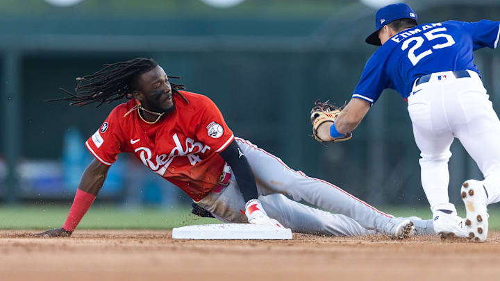 Mar 4, 2025; Phoenix, Arizona, USA; Cincinnati Reds shortstop Elly De La Cruz steals second base ahead of the tag by Los Angeles Dodgers second baseman Tommy Edman during a spring training game at Camelback Ranch-Glendale. Mandatory Credit: Mark J. Rebilas-Imagn Images