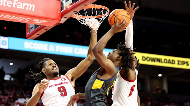 Dec 21, 2024; Fayetteville, Arkansas, USA; North Carolina A&T Aggies guard Ryan Forrest (1) attempts a shot in the first half defended by Arkansas Razorbacks forward Jonas Aidoo (9) at Bud Walton Arena. Mandatory Credit: Nelson Chenault-Imagn Images