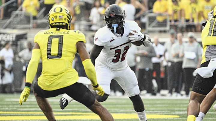 Sep 10, 2022; Eugene, Oregon, USA;  Eastern Washington Eagles running back Tuna Altahir (32) runs with the ball during the first half against Oregon Ducks defensive back Christian Gonzalez (0) at Autzen Stadium. Mandatory Credit: Troy Wayrynen-Imagn Images