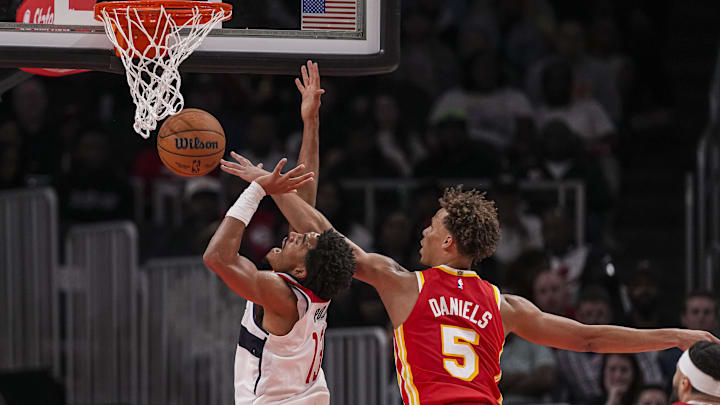 Oct 28, 2024; Atlanta, Georgia, USA; Atlanta Hawks guard Dyson Daniels (5) blocks a shot by Washington Wizards guard Jordan Poole (13) during the second half at State Farm Arena. Mandatory Credit: Dale Zanine-Imagn Images