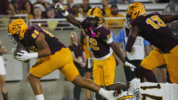 ASU defensive lineman Justin Wodtly (95) returns a fumble for a touchdown against Wyoming during a game at Sun Devil Stadium in Tempe on Aug. 31, 2024. ASU defensive lineman Justin Wodtly (95) returns a fumble for a touchdown against Wyoming during a game at Sun Devil Stadium in Tempe on Aug. 31, 2024.