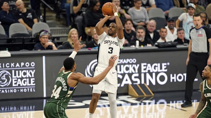 Jan 31, 2025; San Antonio, Texas, USA; San Antonio Spurs guard Chris Paul (3) shoots over Milwaukee Bucks forward Giannis Antetokounmpo (34) during the first half at Frost Bank Center. Mandatory Credit: Scott Wachter-Imagn Images