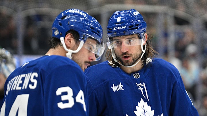 Oct 16, 2024; Toronto, Ontario, CAN; Toronto Maple Leafs defenseman Chris Tanev (8) speaks with forward Auston Matthews in the second period against the Los Angeles Kings at Scotiabank Arena. Mandatory Credit: Dan Hamilton-Imagn Images