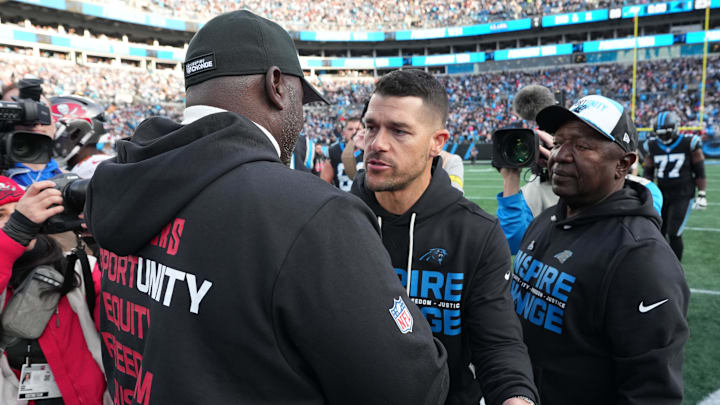 Dec 21, 2025; Charlotte, North Carolina, USA; Carolina Panthers head coach Dave Canales greets Tampa Bay Buccaneers head coach Todd Bowles after a game at Bank of America Stadium. Mandatory Credit: Bob Donnan-Imagn Images
