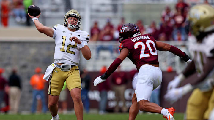 Oct 26, 2024; Blacksburg, Virginia, USA; Georgia Tech Yellow Jackets quarterback Aaron Philo (12) throws a pass against Virginia Tech Hokies linebacker Caleb Woodson (20) during the fourth quarter at Lane Stadium. 