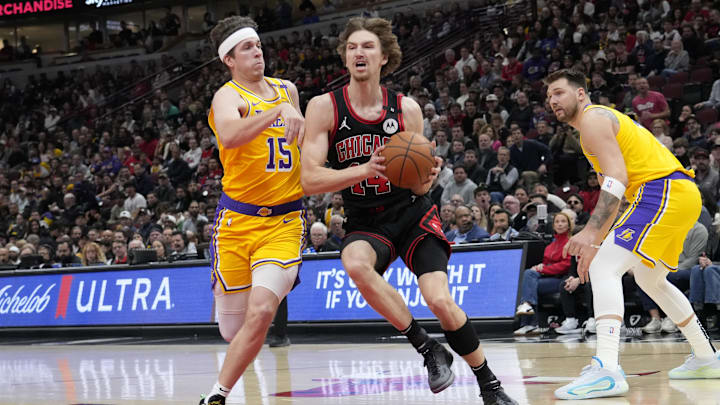 Mar 27, 2025; Chicago, Illinois, USA; Los Angeles Lakers guard Austin Reaves (15) defends Chicago Bulls forward Matas Buzelis (14) 