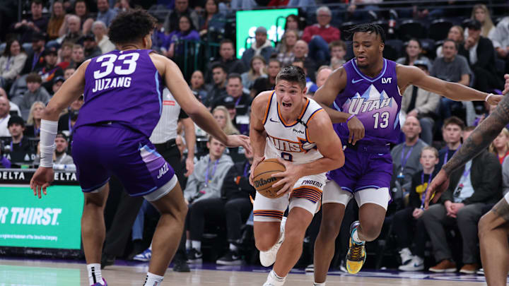 Dec 13, 2024; Salt Lake City, Utah, USA; Phoenix Suns guard Grayson Allen (8) drives between Utah Jazz guard Johnny Juzang (33) and guard Isaiah Collier (13) during the fourth quarter at Delta Center. Mandatory Credit: Rob Gray-Imagn Images