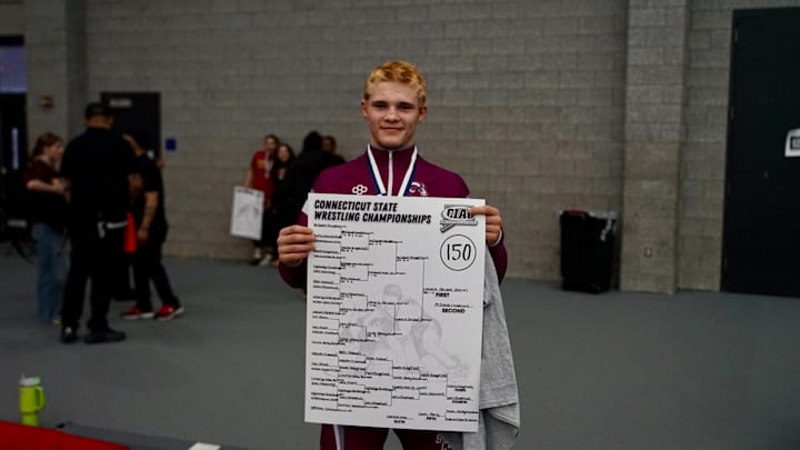 Bristol Central 150-pound wrestler Alex Lamarre is pictured with the 150-pound championship banner after winning the CIAC 150-pound State Open Title on Saturday, February 28, 2026 at the Floyd Little Athletic Center in New Haven, Connecticut. 