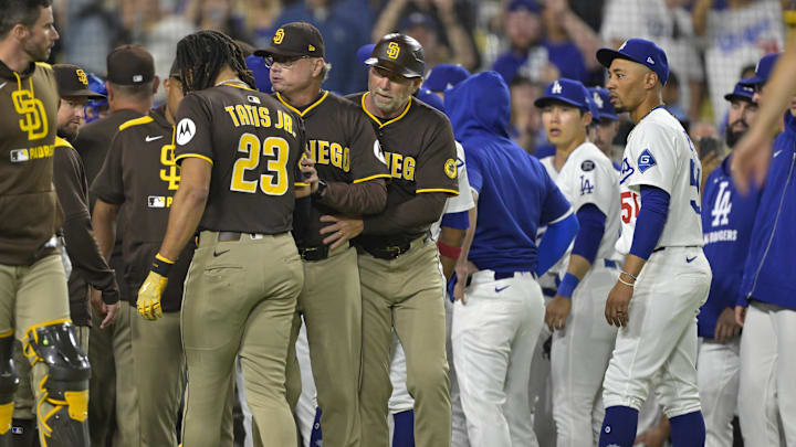 Jun 19, 2025; Los Angeles, California, USA;   San Diego Padres manager Mike Shildt (8) and third base coach Tim Leiper (33) with San Diego Padres right fielder Fernando Tatis Jr. (23) as Los Angeles Dodgers shortstop Mookie Betts (50) looks on after benches cleared in the eighth inning at Dodger Stadium. Mandatory Credit: Jayne Kamin-Oncea-Imagn Images