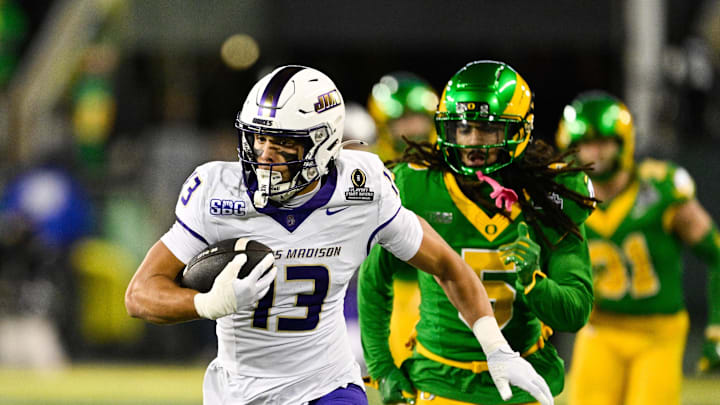 Dec 20, 2025; Eugene, OR, USA; James Madison Dukes wide receiver Landon Ellis (13) runs after making a catch as Oregon Ducks defensive back Theran Johnson (5) defends during the second quarter at Autzen Stadium. Mandatory Credit: Troy Wayrynen-Imagn Images
