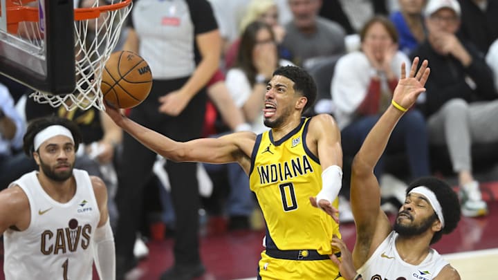 May 6, 2025; Cleveland, Ohio, USA; Indiana Pacers guard Tyrese Haliburton (0) drives to the basket between guard Max Strus (1) and center Jarrett Allen (31) in the fourth quarter during game two of the second round of the 2025 NBA Playoffs at Rocket Arena. Mandatory Credit: David Richard-Imagn Images