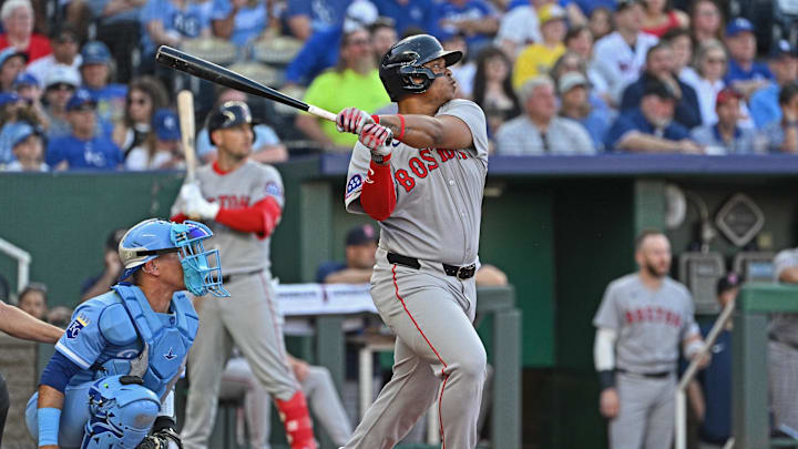 May 10, 2025; Kansas City, Missouri, USA;  Boston Red Sox designated hitter Rafael Devers (11) hits an RBI double in the third inning against the Kansas City Royals at Kauffman Stadium. Mandatory Credit: Peter Aiken-Imagn Images