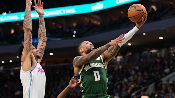 Jan 23, 2025; Milwaukee, Wisconsin, USA; Milwaukee Bucks guard Damian Lillard (0) takes a shot against Miami Heat center Kel'el Ware (7) in the third quarter at Fiserv Forum. Mandatory Credit: Benny Sieu-Imagn Images