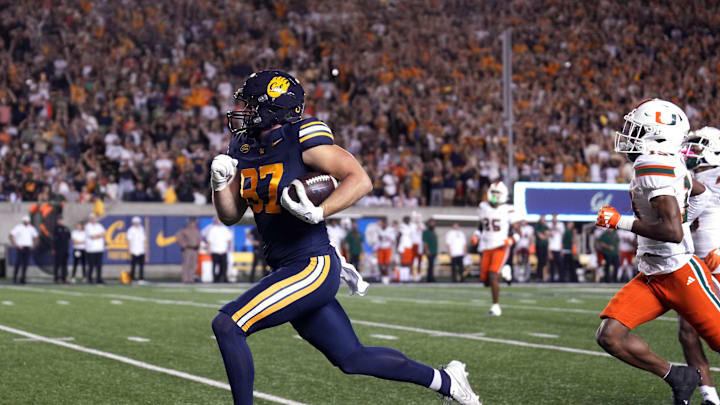 Oct 5, 2024; Berkeley, California, USA; California Golden Bears tight end Jack Endries (87) runs after a catch against Miami Hurricanes defensive back D'Yoni Hill (right) to score a touchdown during the first quarter at California Memorial Stadium. Mandatory Credit: Darren Yamashita-Imagn Images Oct 5, 2024; Berkeley, California, USA; California Golden Bears tight end Jack Endries (87) runs after a catch against Miami Hurricanes defensive back D'Yoni Hill (right) to score a touchdown during the first quarter at California Memorial Stadium. Mandatory Credit: Darren Yamashita-Imagn Images