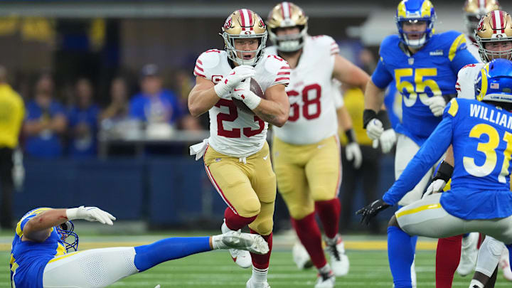 Oct 2, 2025; Inglewood, California, USA; San Francisco 49ers running back Christian McCaffrey (23) rushes the ball against the Los Angeles Rams during the first half at SoFi Stadium. Mandatory Credit: Kirby Lee-Imagn Images
