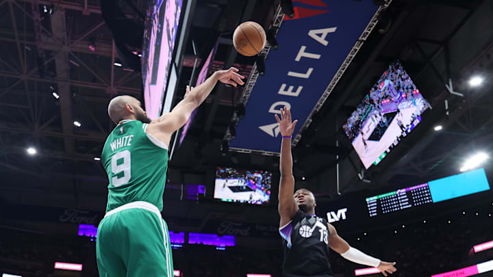 Mar 21, 2025; Salt Lake City, Utah, USA; Boston Celtics guard Derrick White (9) takes a three point shot over Utah Jazz guard Isaiah Collier (13) during the first half at Delta Center. Mandatory Credit: Rob Gray-Imagn Images