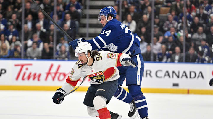 Apr 1, 2024; Toronto, Ontario, CAN; Florida Panthers forward Ryan Lomberg (94) bodychecks Toronto