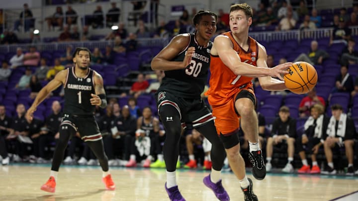 Nov 27, 2024; Fort Myers, Florida, USA; Virginia Tech Hokies guard Brandon Rechsteiner (7) passes the ball past South Carolina Gamecocks forward Collin Murray-Boyles (30)in the first half  at Suncoast Credit Union Arena. Mandatory Credit: Nathan Ray Seebeck-Imagn Images