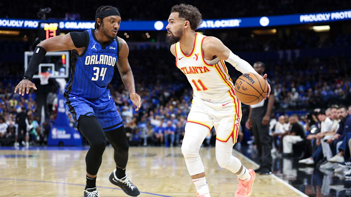 Apr 15, 2025; Orlando, Florida, USA; Atlanta Hawks guard Trae Young (11) controls the ball from Orlando Magic center Wendell Carter Jr. (34) in the first quarter at Kia Center. Mandatory Credit: Nathan Ray Seebeck-Imagn Images