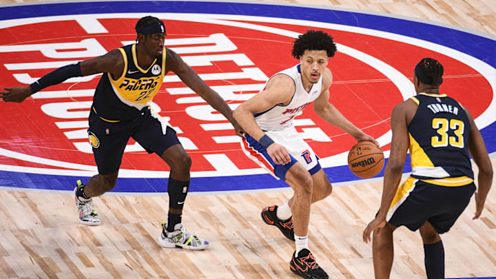 Nov 17, 2021; Detroit, Michigan, USA; Detroit Pistons guard Cade Cunningham (2) drives to the basket as Indiana Pacers center Myles Turner (33) and guard Caris LeVert (22) defend during the third quarter at Little Caesars Arena. Mandatory Credit: Tim Fuller-Imagn Images