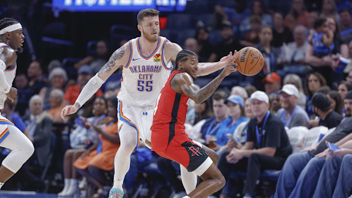 Oct 9, 2024; Oklahoma City, Oklahoma, USA; Oklahoma City Thunder center Isaiah Hartenstein (55) tips the ball away from Houston Rockets guard Jalen Green (4) during the second quarter at Paycom Center. Mandatory Credit: Alonzo Adams-Imagn Images