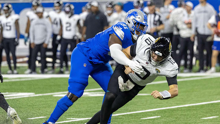 Nov 17, 2024; Detroit, Michigan, USA; Jacksonville Jaguars quarterback Mac Jones (10) passes the ball and is pressured by Detroit Lions defensive end Levi Onwuzurike (91) during the second half at Ford Field. Mandatory Credit: David Reginek-Imagn Images Nov 17, 2024; Detroit, Michigan, USA; Jacksonville Jaguars quarterback Mac Jones (10) passes the ball and is pressured by Detroit Lions defensive end Levi Onwuzurike (91) during the second half at Ford Field. Mandatory Credit: David Reginek-Imagn Images