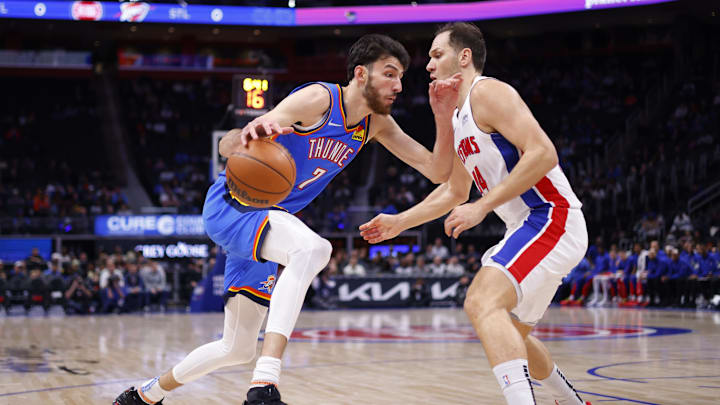Jan 28, 2024; Detroit, Michigan, USA;  Oklahoma City Thunder forward Chet Holmgren (7) dribbles defended by Detroit Pistons forward Bojan Bogdanovic (44) in the first half at Little Caesars Arena. Mandatory Credit: Rick Osentoski-Imagn Images