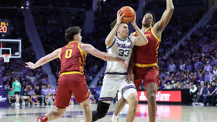 Mar 8, 2025; Manhattan, Kansas, USA; Kansas State Wildcats forward Coleman Hawkins (33) drives to the basket against Iowa State Cyclones guard Nate Heise (0) and center Dishon Jackson (1) during the first half at Bramlage Coliseum. Mandatory Credit: Scott Sewell-Imagn Images Mar 8, 2025; Manhattan, Kansas, USA; Kansas State Wildcats forward Coleman Hawkins (33) drives to the basket against Iowa State Cyclones guard Nate Heise (0) and center Dishon Jackson (1) during the first half at Bramlage Coliseum. Mandatory Credit: Scott Sewell-Imagn Images
