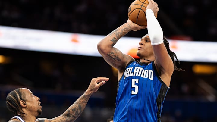 Mar 29, 2025; Orlando, Florida, USA; Orlando Magic forward Paolo Banchero (5) shoots the ball over Sacramento Kings guard Malik Monk (0) in the fourth quarter at Kia Center. Mandatory Credit: Jeremy Reper-Imagn Images