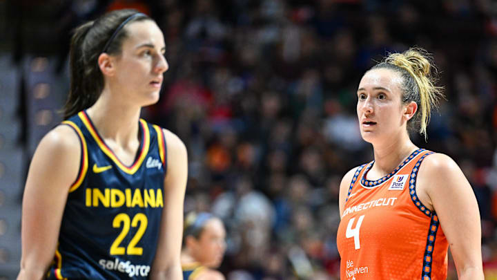 Sep 22, 2024; Uncasville, Connecticut, USA; Connecticut Sun guard Marina Mabrey (4) stares at Indiana Fever guard Caitlin Clark (22) in the third quarter during game one of the first round of the 2024 WNBA Playoffs at Mohegan Sun Arena. Mandatory Credit: Mark Smith-Imagn Images Sep 22, 2024; Uncasville, Connecticut, USA; Connecticut Sun guard Marina Mabrey (4) stares at Indiana Fever guard Caitlin Clark (22) in the third quarter during game one of the first round of the 2024 WNBA Playoffs at Mohegan Sun Arena. Mandatory Credit: Mark Smith-Imagn Images
