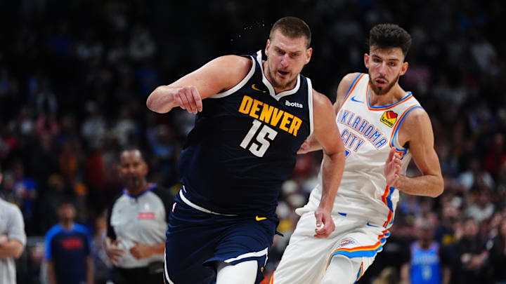 Nov 6, 2024; Denver, Colorado, USA; Denver Nuggets center Nikola Jokic (15) drives past Oklahoma City Thunder forward Chet Holmgren (7) in the second half at Ball Arena. Mandatory Credit: Ron Chenoy-Imagn Images