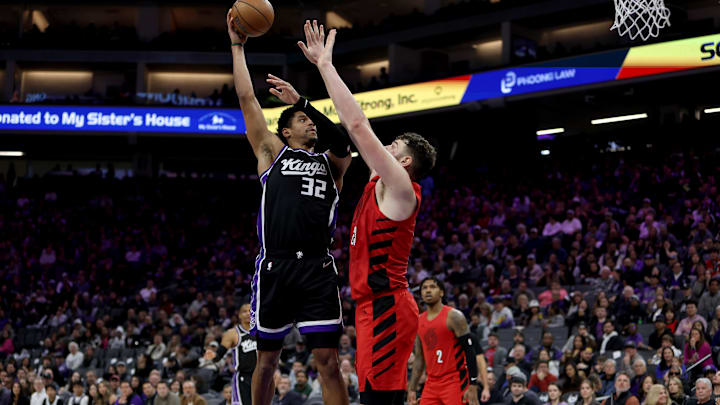 Jan 18, 2026; Sacramento, California, USA; Sacramento Kings center Dylan Cardwell (32) shoots over Portland Trail Blazers center Donovan Clingan (23) during the third quarter at Golden 1 Center.