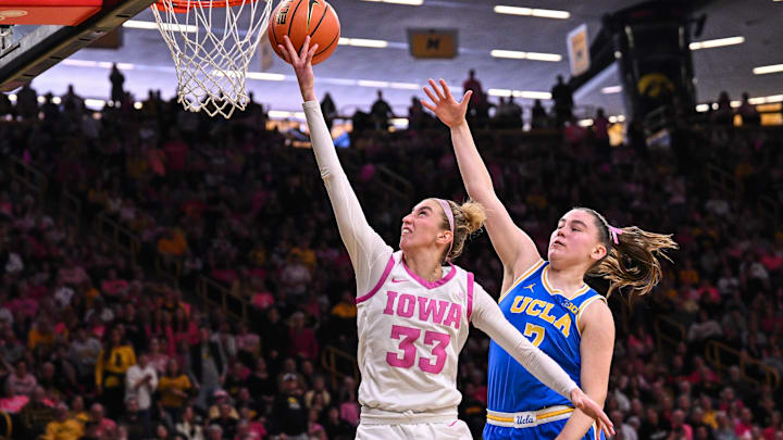 Feb 23, 2025; Iowa City, Iowa, USA; Iowa Hawkeyes guard Lucy Olsen (33) goes to the basket as UCLA Bruins guard Elina Aarnisalo (7) defends during the third quarter at Carver-Hawkeye Arena. Mandatory Credit: Jeffrey Becker-Imagn Images Feb 23, 2025; Iowa City, Iowa, USA; Iowa Hawkeyes guard Lucy Olsen (33) goes to the basket as UCLA Bruins guard Elina Aarnisalo (7) defends during the third quarter at Carver-Hawkeye Arena. Mandatory Credit: Jeffrey Becker-Imagn Images