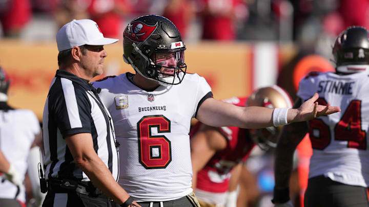 Nov 19, 2023; Santa Clara, California, USA; Tampa Bay Buccaneers quarterback Baker Mayfield (6) talks to referee Craig Wrolstad (left) during the first quarter against the San Francisco 49ers at Levi's Stadium. Mandatory Credit: Darren Yamashita-Imagn Images