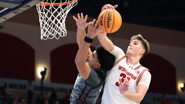 Nov 28, 2025; San Diego, CA, USA; Wisconsin Badgers forward Nolan Winter (31) blocks Texas Christian University Horned Frogs forward David Punch (15) during the second half at Jenny Craig Pavilion. 