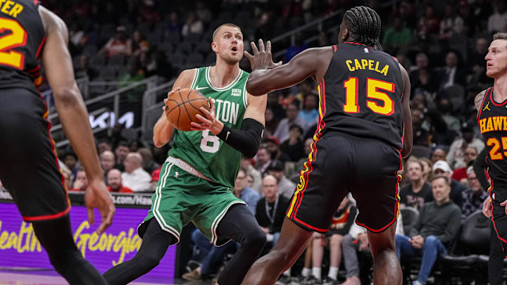 Mar 28, 2024; Atlanta, Georgia, USA; Boston Celtics center Kristaps Porzingis (8) tries to get to the basket against Atlanta Hawks center Clint Capela (15) during the first half at State Farm Arena. Mandatory Credit: Dale Zanine-Imagn Images