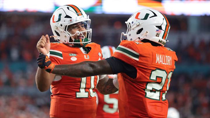 Oct 17, 2026; Miami Gardens, Florida, USA;  Miami Hurricanes running back Javian Mallory (21) celebrates with quarterback Darian Mensah (10) after a touchdown during the fourth quarter against the Florida State Seminoles at Hard Rock Stadium.  Mandatory Credit: Sam Navarro-Imagn Images