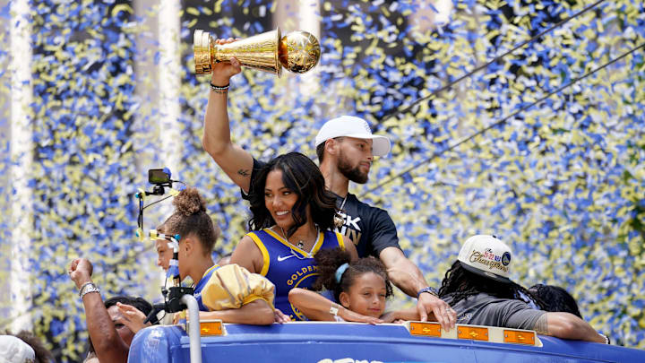 Jun 20, 2022; San Francisco, CA, USA; Golden State Warriors guard Stephen Curry holds the NBA Finals Most Valuable Player Award trophy next to his wife Ayesha during the Warriors championship parade in downtown San Francisco. Mandatory Credit: Cary Edmondson-Imagn Images