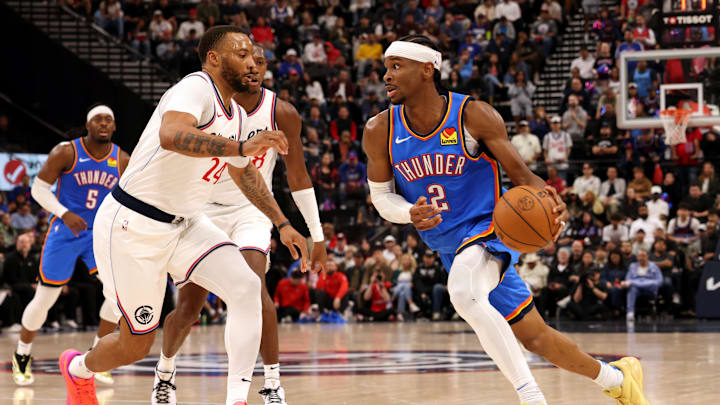 Mar 23, 2025; Inglewood, California, USA; Oklahoma City Thunder guard Shai Gilgeous-Alexander (2) drives against LA Clippers guard Norman Powell (24) during the 3rd quarter at Intuit Dome. Mandatory Credit: Jason Parkhurst-Imagn Images