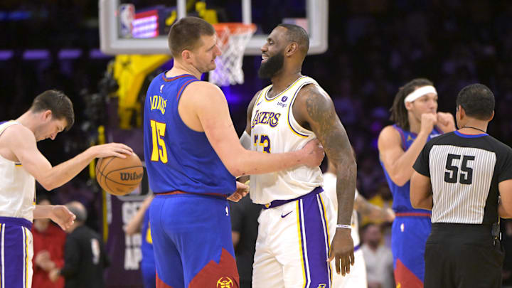 Mar 2, 2024; Los Angeles, California, USA;  Los Angeles Lakers forward LeBron James (23) is greeted by Denver Nuggets center Nikola Jokić (15)