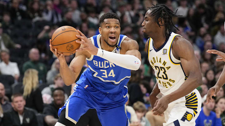 Mar 15, 2025; Milwaukee, Wisconsin, USA;  Milwaukee Bucks forward Giannis Antetokounmpo (34) looks to pass the ball around Indiana Pacers forward Aaron Nesmith (23) during the third quarter at Fiserv Forum. Mandatory Credit: Jeff Hanisch-Imagn Images
